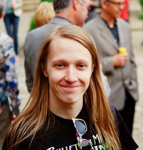 Matthew Swithinbank smiling in a black t-shirt
